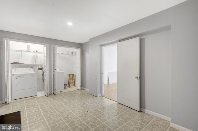 washroom with light floors, washer / clothes dryer, baseboards, and laundry area