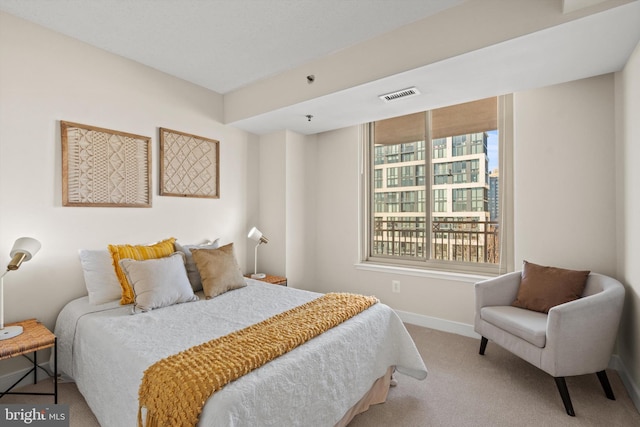 carpeted bedroom featuring multiple windows