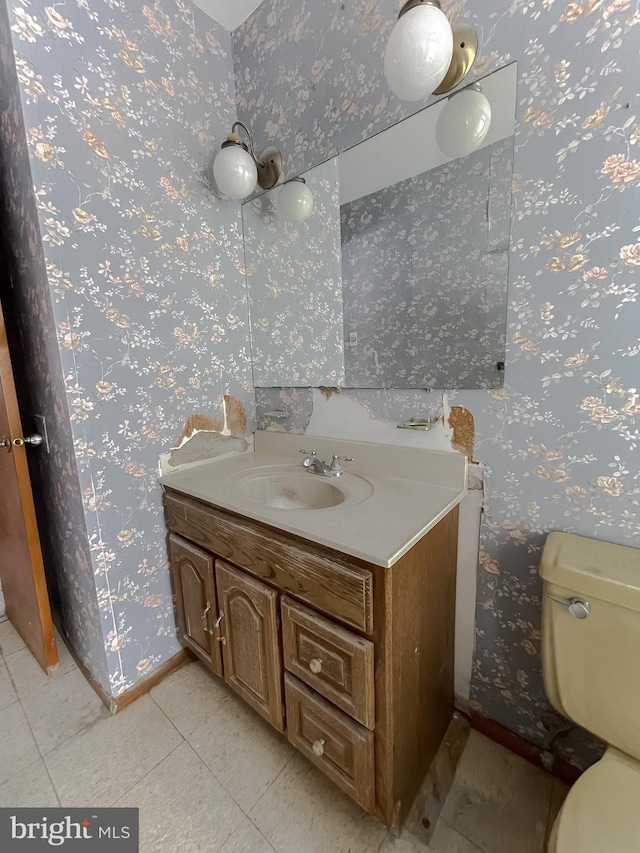 bathroom with vanity, tile patterned flooring, and toilet