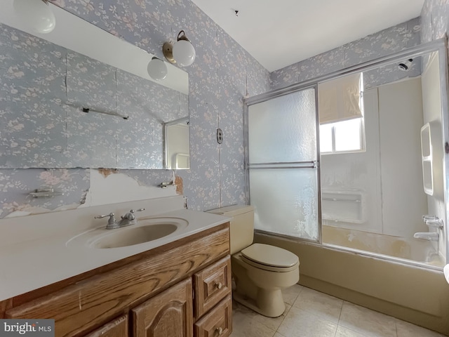 full bathroom featuring tile patterned flooring, enclosed tub / shower combo, vanity, and toilet