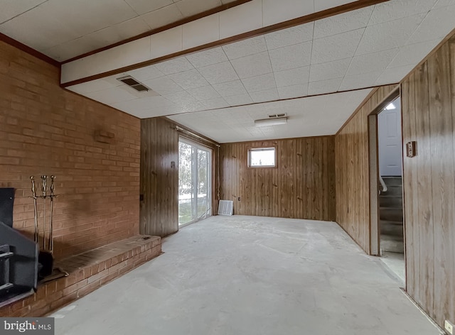 basement featuring wooden walls