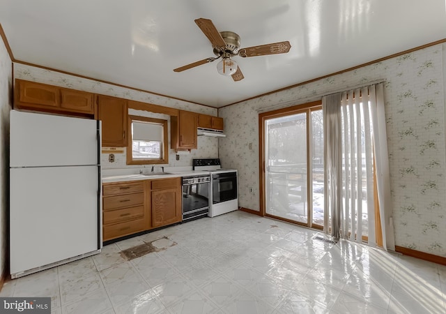 kitchen with white appliances, ornamental molding, and sink