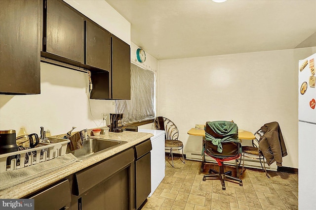 kitchen featuring sink, dark brown cabinets, and white refrigerator