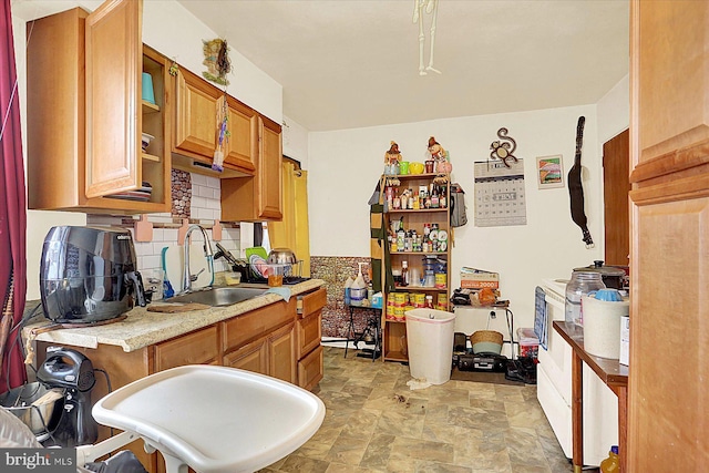 kitchen featuring tasteful backsplash and sink