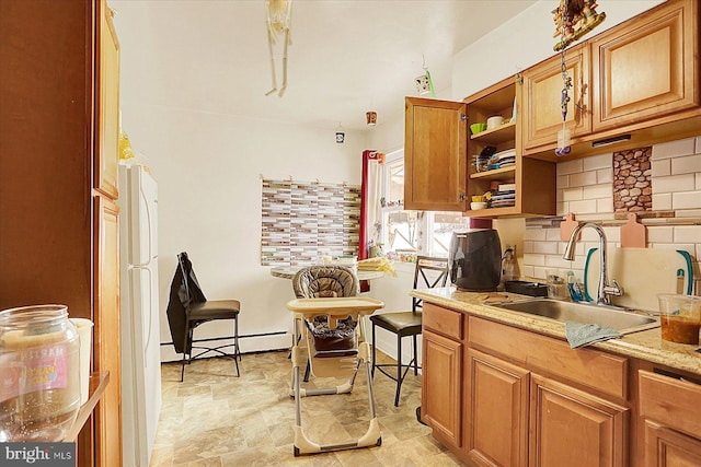 kitchen with tasteful backsplash, a baseboard radiator, and sink