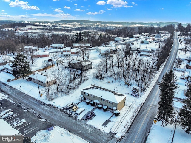 snowy aerial view with a mountain view