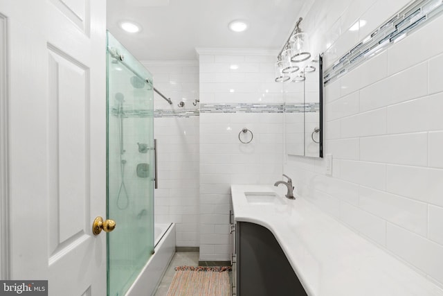 bathroom with vanity, tile patterned floors, shower / bath combination with glass door, and tile walls