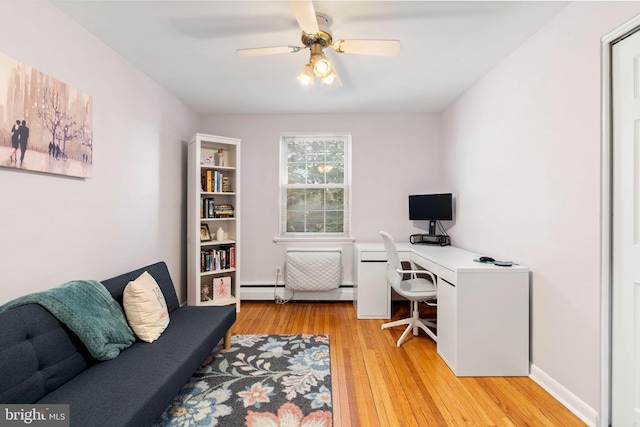 office area with ceiling fan, light wood-type flooring, and baseboard heating