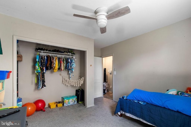 carpeted bedroom with ceiling fan and a closet