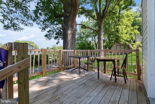 wooden terrace featuring a shed