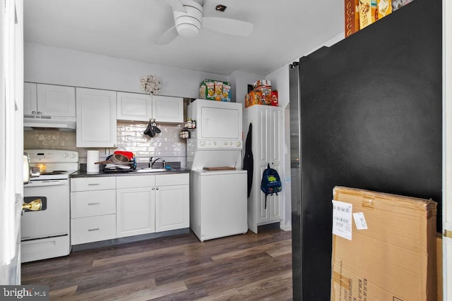 kitchen featuring stacked washer and dryer, white electric range, sink, white cabinetry, and dark hardwood / wood-style flooring