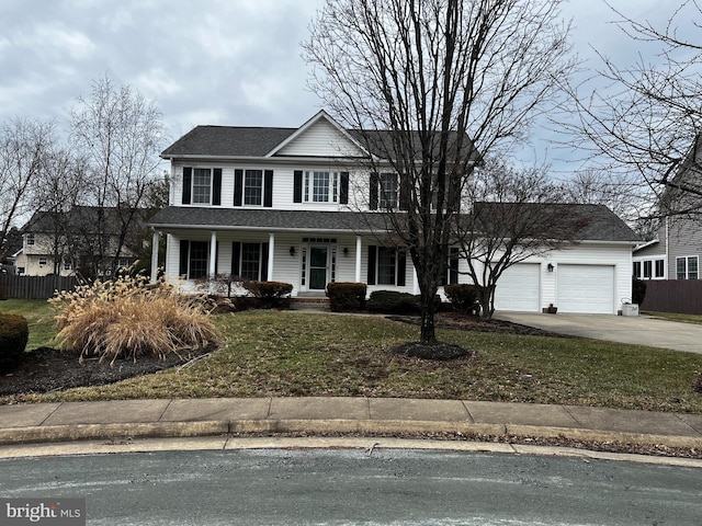 view of front of house with an attached garage, fence, concrete driveway, roof with shingles, and a front lawn