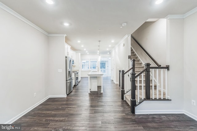 unfurnished living room with ornamental molding and dark hardwood / wood-style flooring