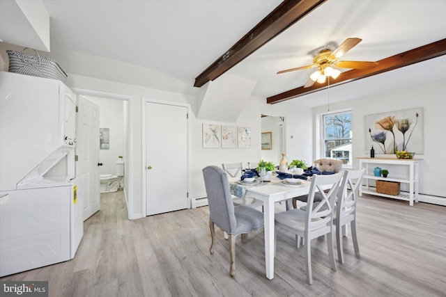 dining area featuring beamed ceiling, a baseboard heating unit, stacked washer / drying machine, and light hardwood / wood-style floors