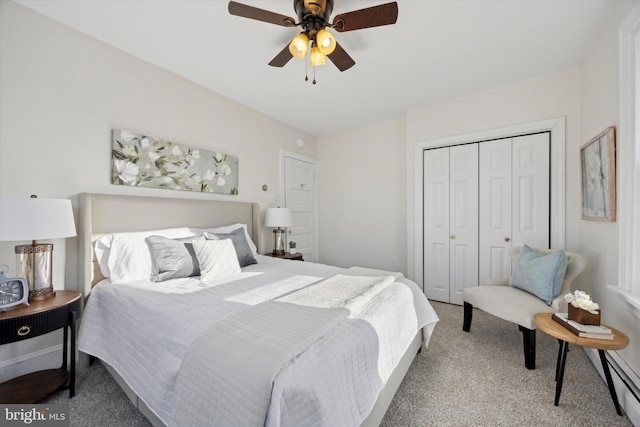 carpeted bedroom featuring a closet, ceiling fan, and baseboard heating