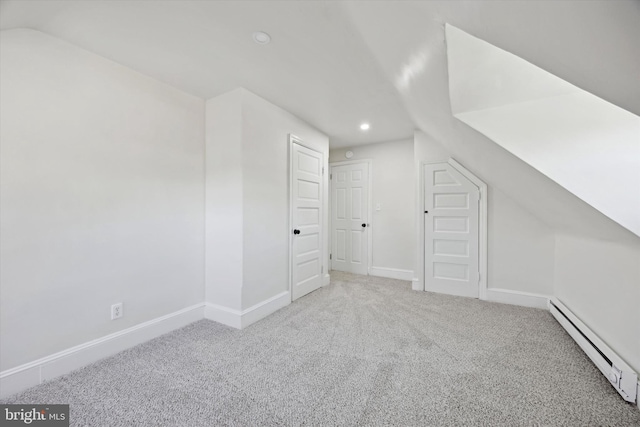 additional living space with carpet floors, vaulted ceiling, and baseboard heating