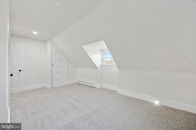 bonus room with lofted ceiling, a baseboard heating unit, and light carpet