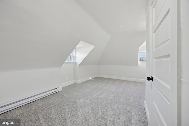 additional living space featuring baseboard heating, carpet flooring, and vaulted ceiling