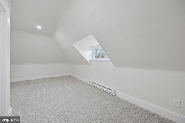 bonus room featuring a baseboard radiator, lofted ceiling, and light colored carpet