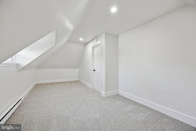 bonus room with vaulted ceiling, carpet, and a baseboard heating unit