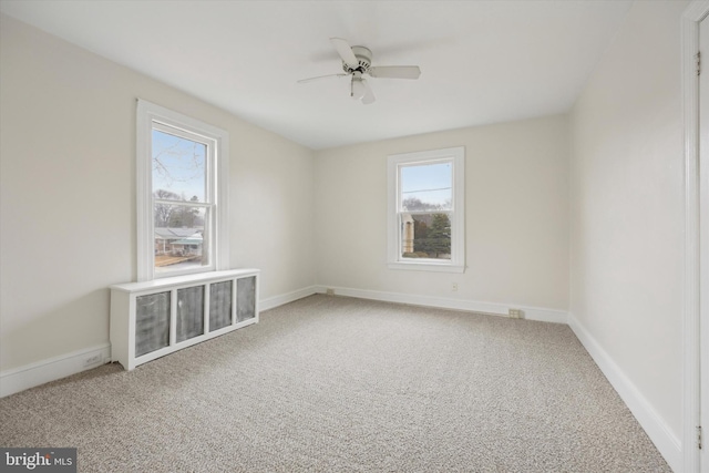 spare room featuring carpet and ceiling fan