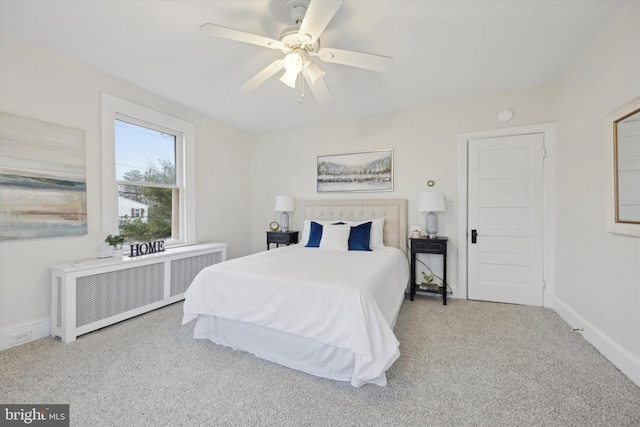 bedroom featuring ceiling fan, light colored carpet, and radiator heating unit