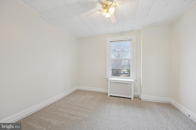 unfurnished room with ceiling fan and carpet