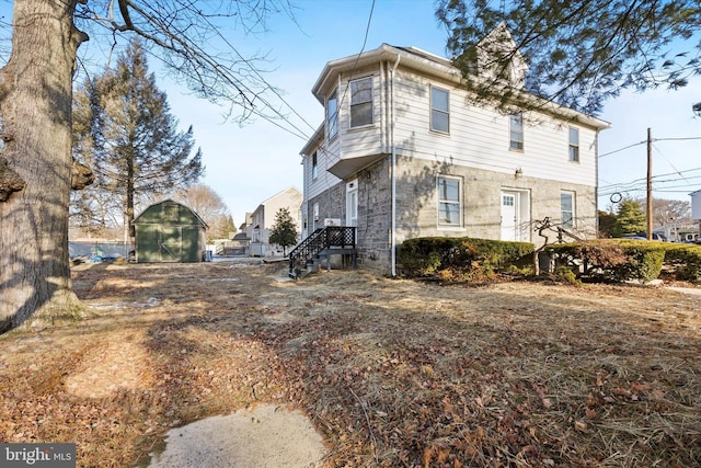 view of side of property featuring a storage unit