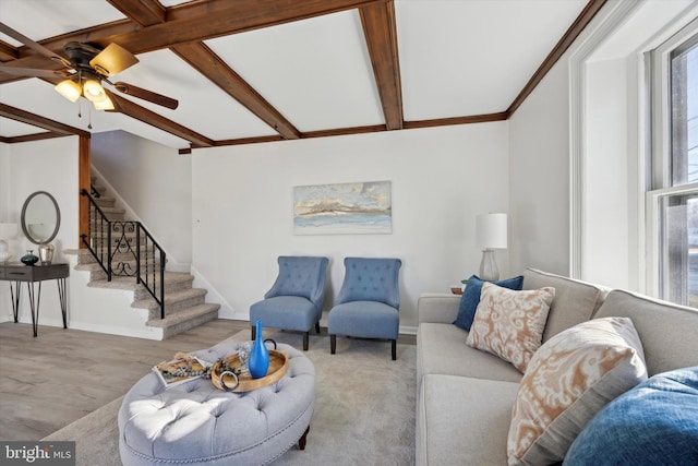 living room with beamed ceiling, ceiling fan, and light hardwood / wood-style flooring