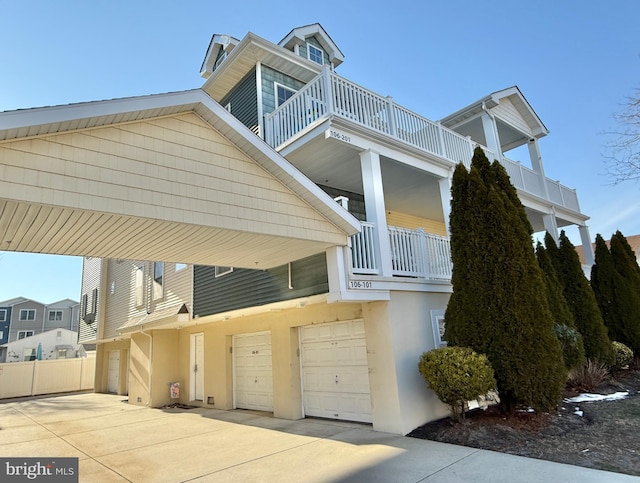 view of property exterior with a garage and a balcony