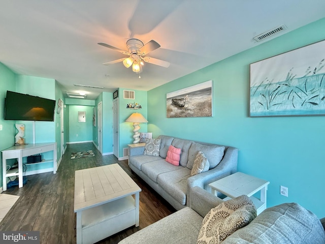 living room with ceiling fan and dark hardwood / wood-style floors