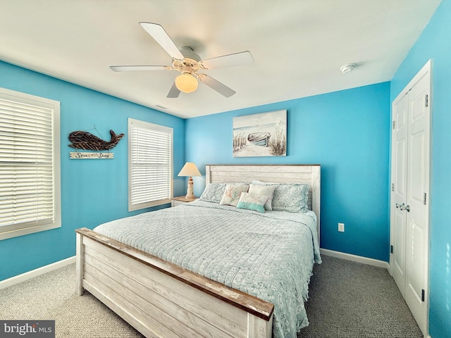 carpeted bedroom with a closet and ceiling fan