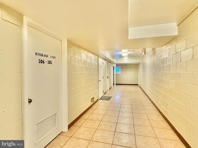 corridor with light tile patterned floors