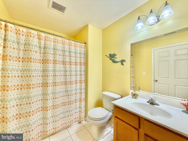 bathroom with tile patterned flooring, vanity, and toilet