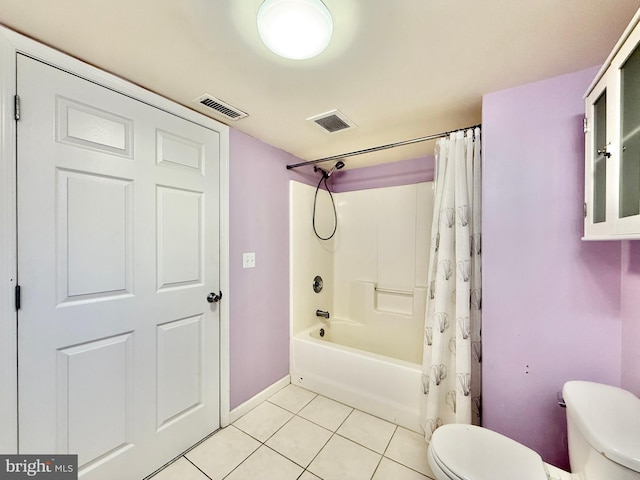 bathroom featuring tile patterned flooring, shower / bath combo, and toilet