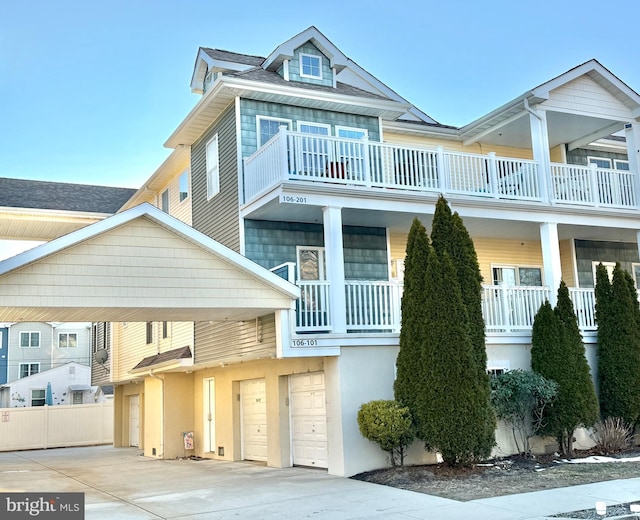 view of property with a garage and a balcony