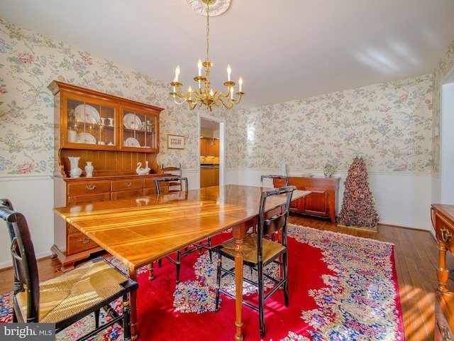 dining room featuring hardwood / wood-style flooring and a notable chandelier