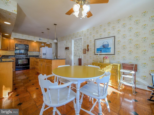 dining room featuring sink and ceiling fan