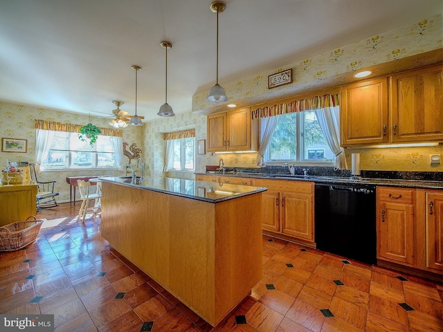 kitchen featuring pendant lighting, dishwasher, sink, light parquet floors, and a center island