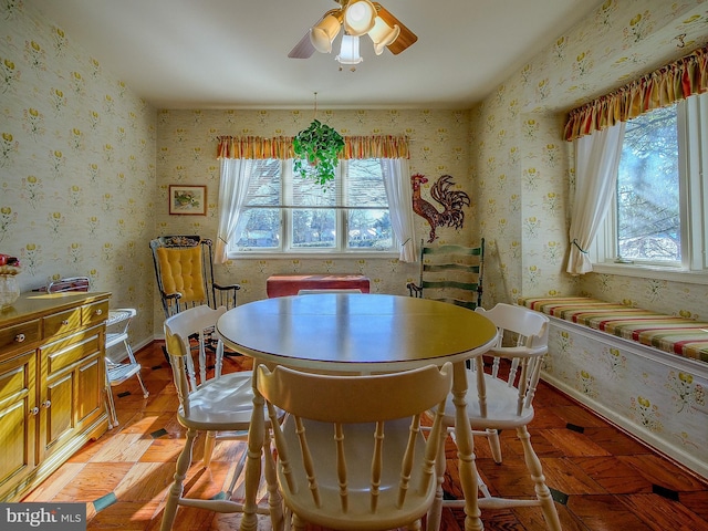 dining space featuring ceiling fan and light parquet floors