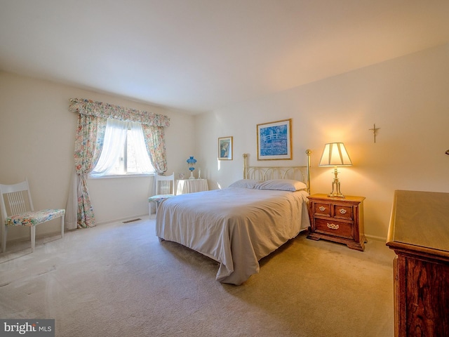 bedroom featuring light colored carpet