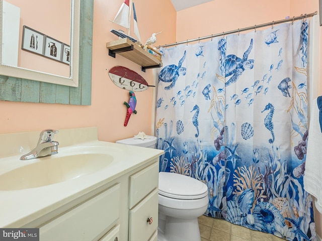 bathroom featuring a shower with curtain, vanity, tile patterned floors, and toilet