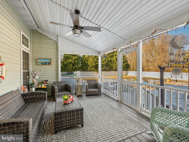 sunroom featuring ceiling fan, lofted ceiling, and a wealth of natural light