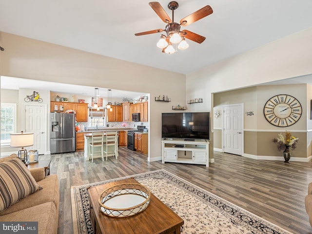 living room with hardwood / wood-style flooring and ceiling fan