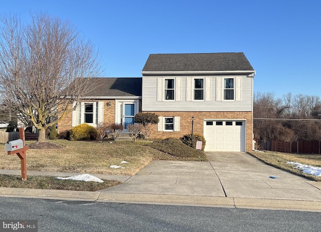 split level home with a garage, brick siding, driveway, and fence