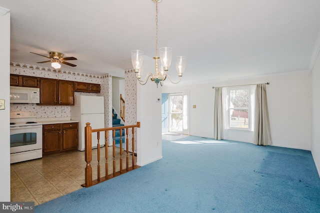 kitchen featuring baseboards, decorative light fixtures, light countertops, light carpet, and white appliances