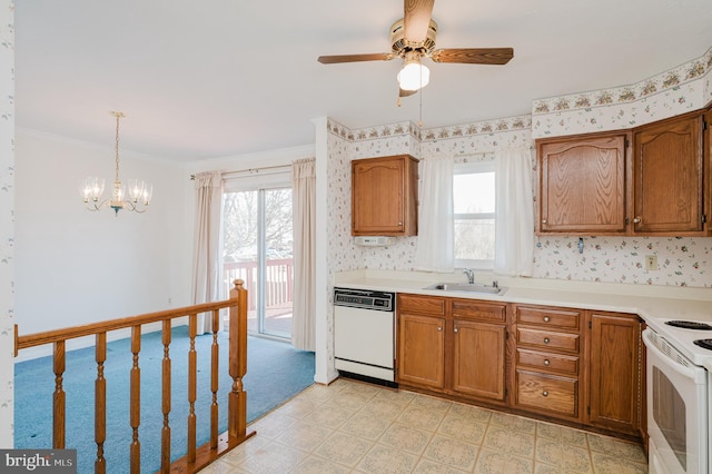 kitchen with wallpapered walls, white appliances, brown cabinetry, and a sink