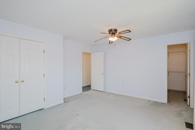 unfurnished bedroom with visible vents, ceiling fan, baseboards, carpet floors, and a closet