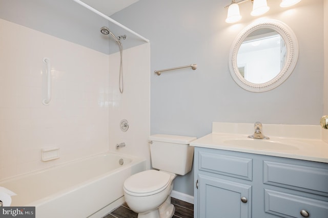 bathroom featuring toilet, vanity, and bathing tub / shower combination