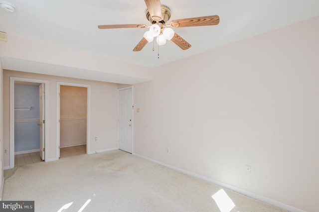 unfurnished bedroom featuring light carpet, ceiling fan, and baseboards